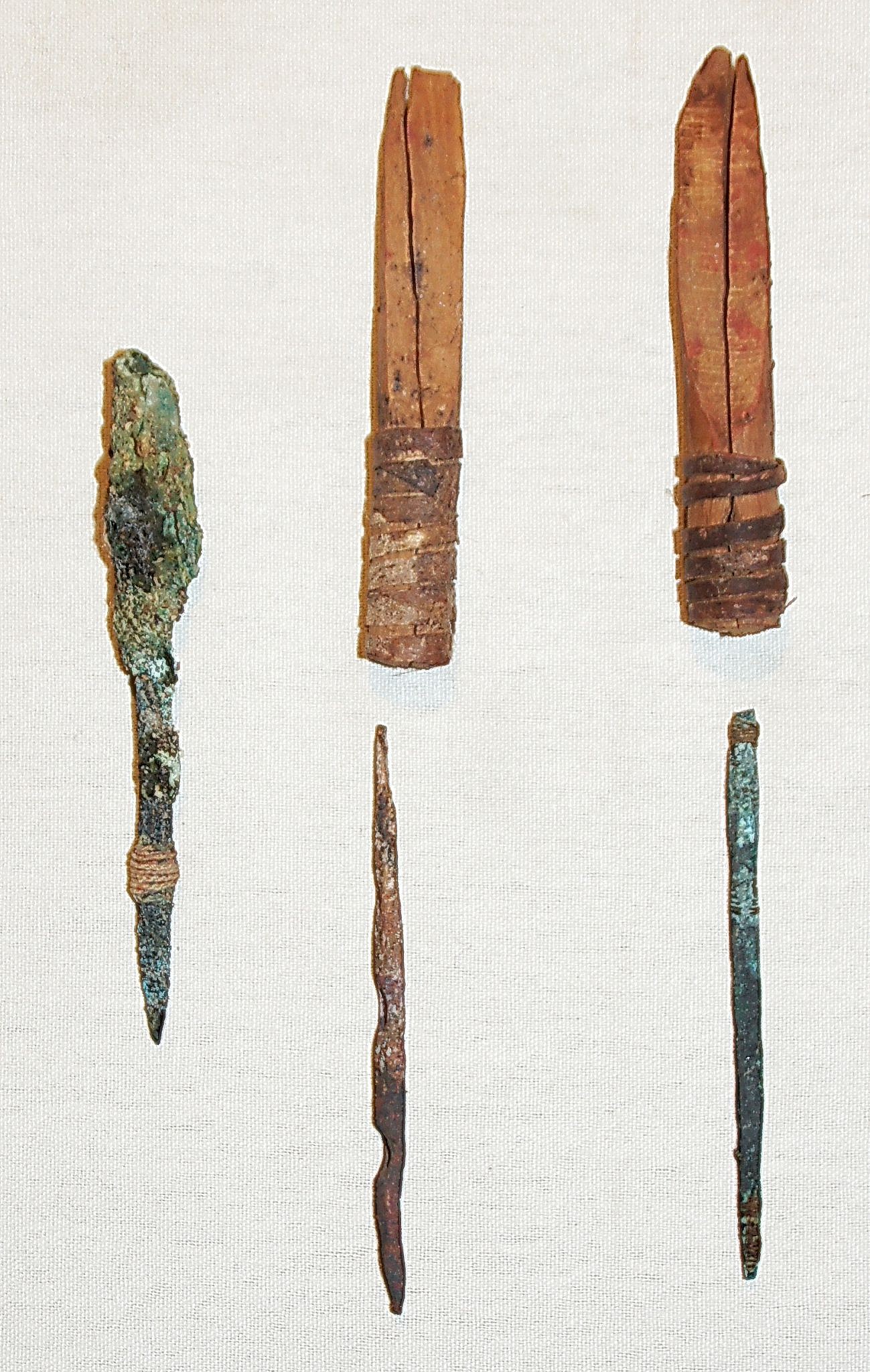 Chile, Three Copper Drill Bits and Two Wood Drill Chucks
Wood drill chucks were split lengthwise and cut on a bevel, the wrapped with together with gut.  A copper drill bit was inserted into the chuck and tightened gut.  The beveled end was attached to a beveled wooden shaft and worked with a bow drill.
Media: Wood
Dimensions: Length: 2.5"
n6027