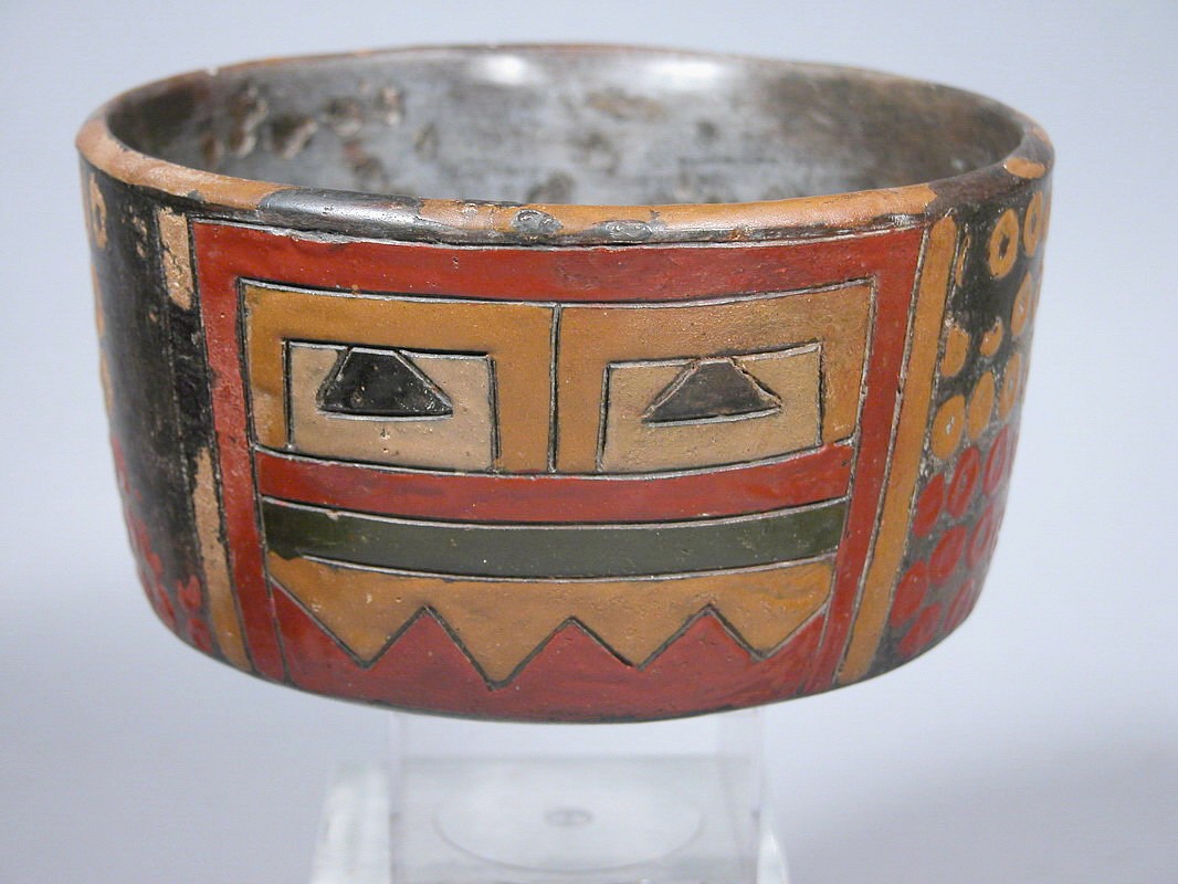 Peru, Paracas Polychrome Bowl with Incised Mask Design
This Paracas bowl was decorated with an abstracted geometric mask painted in rich post-fire pigments of red, ochre, olive green, and buff.  The bowl also features geometric checkerboard patterns to the left and right of the face. There is a slight lip on the upper rim for pouring or drinking ritual libations.  Abstract geometric vessels such as this were highly sought after by European and American painters during the heyday of the Modernist movement in the early and Mid-20th Century. A similar example is on display at the Metropolitan Museum of Art in New York and is illustrated in Alan Sawyer's, "Ancient Peruvian Ceramics," 1966, on page 74. This vessel has excellent provenance. It was acquired prior to 1970 and was loaned by the Landmann family of Westchester, NY, to the American Museum of Natural History in New York, where it was on view from 1984 to 1994. Period: Peru, Paracas, Late Phase, South Coast, c. 300 - 200 BC
Media: Ceramic
Dimensions: Height 3.14" Diameter 5.3/4"
$16,500
94081