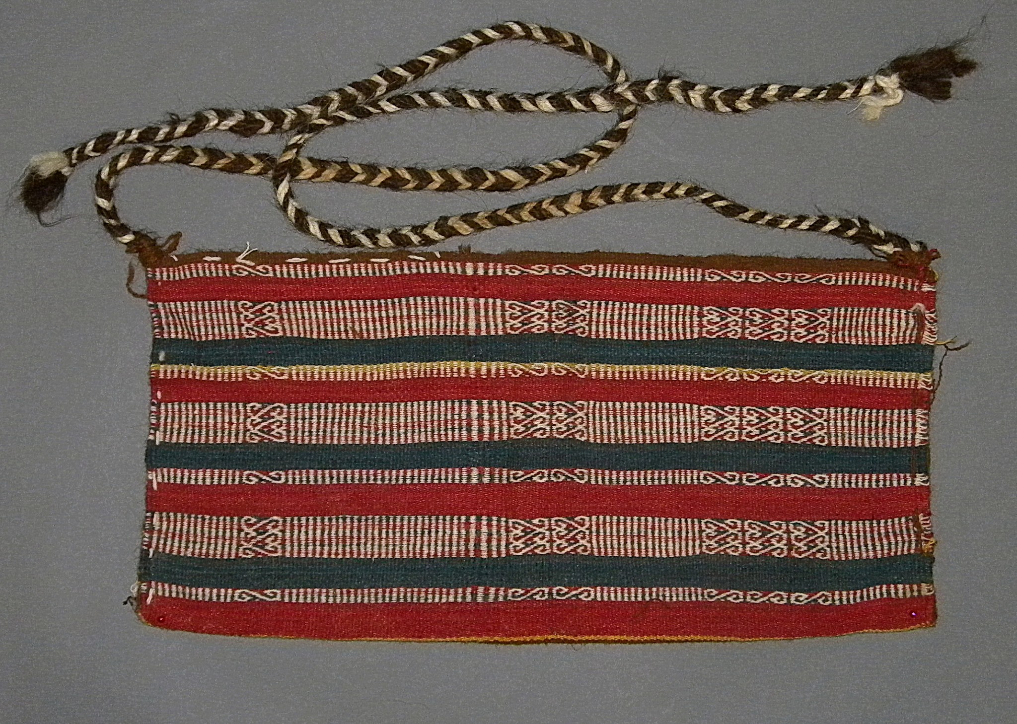 Chile, Inca Faja Bolsa (Bag Belt)
This Faja Bolsa has  extremely good colors and presevation, in blue, red and white. geometric striped design.  The belt was worn around the waist and over a tunic. As tunics have not pockets, the bag belt allowed the wearer to store items from coca leaves to corn, something like a Money Belt is used for today.  A  similar example is found in "Arica, Diez mil Anos", Museo Chileno de Arte Precolombino, page 80, no. 180 & 181. Woven of alpaca wools. Weavings from Pica, Chile are usually in excellent condition with bright colors.
Media: Textile
Dimensions: Width: 6  x  Length:. 17 � in.
$2,750
90247