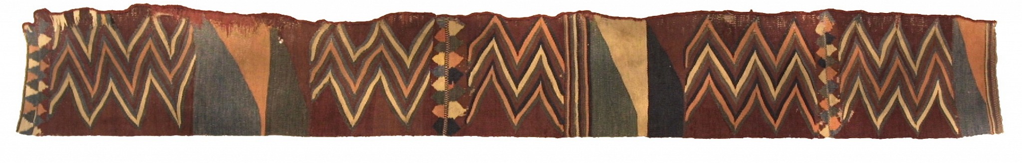 Peru, Nazca kilim-style border to tunic with alternating zig zags
The zig-zags on this border are separated by bold triangular fields with ivory, blue and orange on brown ground.  This weaving is one of the vertical side borders to the tunic.
Media: Textile
Dimensions: Length 83" x  Width 14 1/2"
$11,500
91091