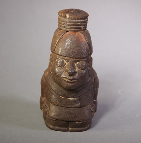 Peru - Large Wari wooden lime container in the form of a seated man Price Upon Request