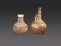 Peru, Two Wari Strap Handle Effigy Vessels with Faces on Spouts
Ceramic