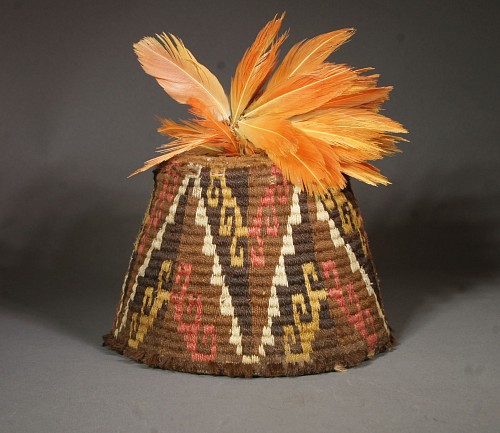 Inca fez style hat with step design in brown, gold, white and pink and feather plume Price Upon Request