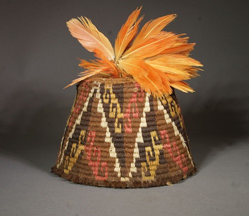 Textile: Inca fez style hat with step design in brown, gold, white and pink and feather plume $5,500