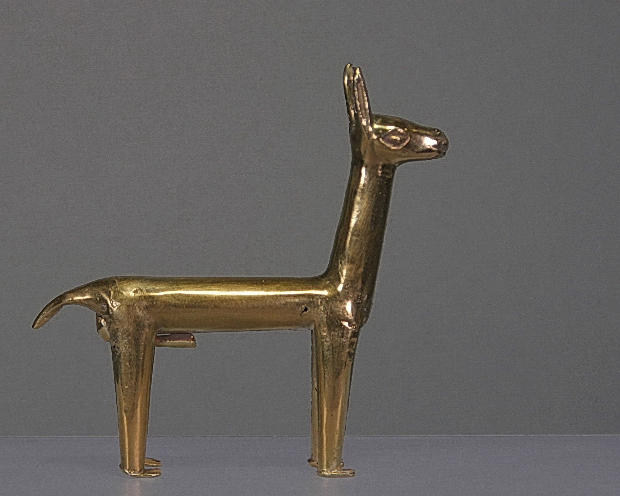 Peru, Inca Gold Hollow Llama
These Llamas, along with other miniatures in gold, silver and spondylus were found at high altitude sacrificial burials sites, used in a ceremony known as the Capac Hucha ceremony to praise the Inca.  A similar llama is illustrated in ANCIENT AMERICANS, Art From Sacred Landscapes p. 362.  This hollow llama was assembled from hammered gold sheets which were soldered together.  One seam can be easily seen along the underside.  Ex. New York collector, prior to 1970.
Media: Metal
Dimensions: Height: 2.5"   Weight: grams 9.6XRF: Au. 66.4%, Ag. 24.6% , Cu8.8%
&bull;SOLD
n7053