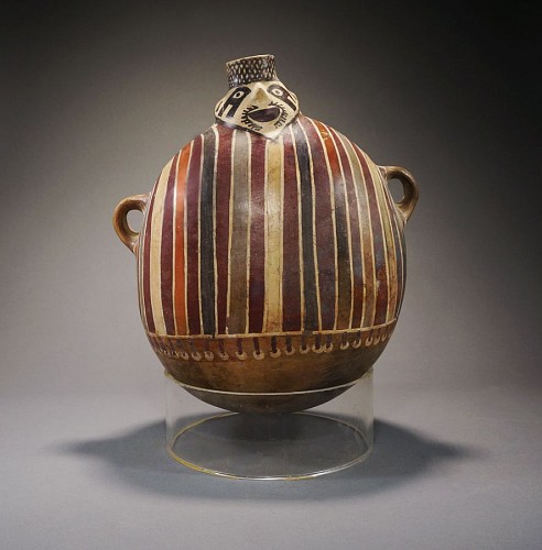 Ceramic: Nazca lug handled vessel wearing a striped tunic Price Upon Request