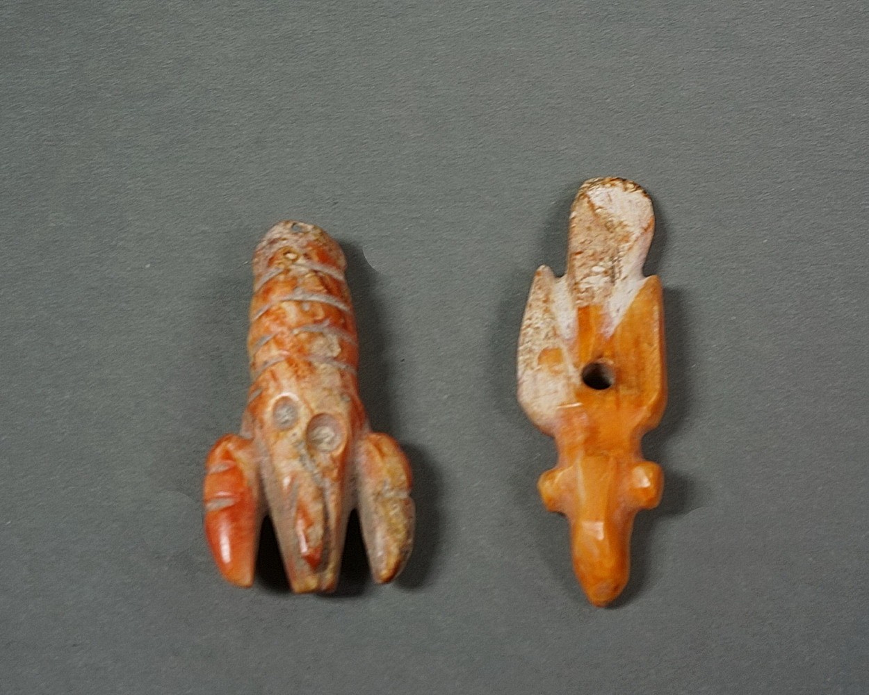 Peru, Chimu Carved Crayfish and Bird Pendants Carved from Spondylus Shells
The pendant on the left depicts a crayfish, while the one on the right represents a marine bird.  Crayfish are found in the fresh water rivers along the Peruvian coast.  Both pendants have suspension holes for attachment to a bracelet or necklace.  Best seen from above, the bird has protruding eyes and a long tail.  Both items are the types of Spondylus artifacts that are found on Peruvian North Coast Capa Pacha (child sacrifice ceremony). This is in discussed in PYRAMIDS OF TUCUME- The quest frof the Peru's Forgotten City by Thor Hyerdahl and Daniel Sandweisspg,106-112
Media: Shell
Dimensions: Crayfish  Length: 1 3/8"Bird Length:  1 1/2"
$1,250
N7002