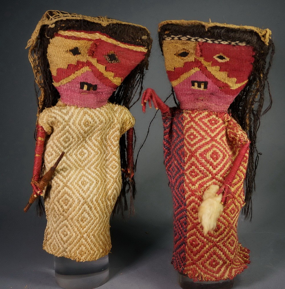 Peru, Two Female Chancay Dolls Each
The female tapestry faces are divided into three sections while those of the males are woven in two sections.  One holds a wad of unspun cotton while the other holds a spindle with brown cotton strapped around it.  Each has a witch’s veil covering the back of the head.  Ex collection Justin and Barbara Kerr, prior to 1970.
Media: Textile
Dimensions: Height: 10 1/4" x Width of Face:  4 1/4"
$8,500
n7013