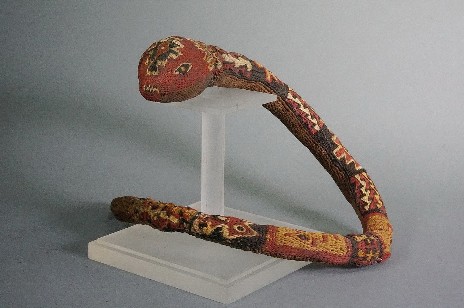 Peru, Wari three dimensional coil woven snake dance wand
Shamans use dance wands hypnotize their attendants.   This wand has 6 different patterns on its back and a solid brown underside.  The tip has a 3" section of woven hemp which appears to be poisonous. There are many poisonous snakes in Peru including the dangerous Bushmaster.   Formerly in the collection of Justin and Barbara Kerr, acquired from Alan Lapiner in 1967.
Media: Textile
Dimensions: Length: 19 1/2" x Diameter: 1 1/2" tapering to 3/8"
$4,000
n7016