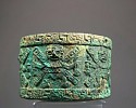 Peru, Moche Cylindrical Container with 6 Decapitators in High Relief
Metal