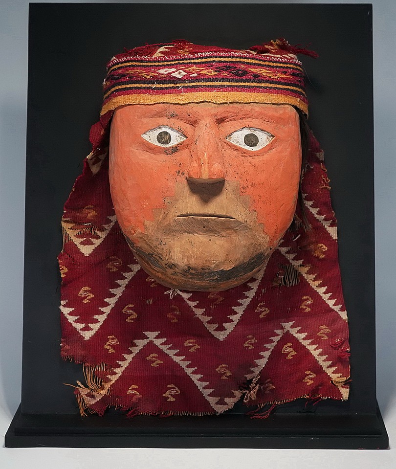 Peru, Three-Dimensional Huacho Carved Wood Mask with Headband
This wood mask with headband has an applied cinnabar decoration with an unusual step design around the mouth. This is an exceptional mask for Peru in that it is well carved in the round with a high degree of realism.  Most of the wood masks from Peru are carved from flat slabs of wood with a small nose which is sometimes made separately and attached.
Media: Wood
Dimensions: H. 7 x W. 6 in. mask only
$22,500
91005