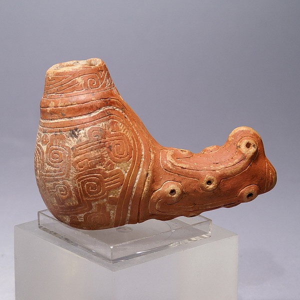 Brazil, Marajo Ceramic container in the form of a Mythical Cayman
These containers are highly valued because of the quality of artistry.  They have a hole to tie a string through, either for suspension or to attach a cover.  This vessel has a stylized Cayman's snout and finely incised designs depicting stylized birds’ heads on the chamber.  Similar vessels illustrating a Cayman's head can be found in UNKNOWN AMAZON, on page 150 and in the catalog O MUSEU PARAENSE EMILIO GOELDI, on page 134.
Media: Ceramic
Dimensions: Length 4.4" x Height  3.1"
$3,800
N1056