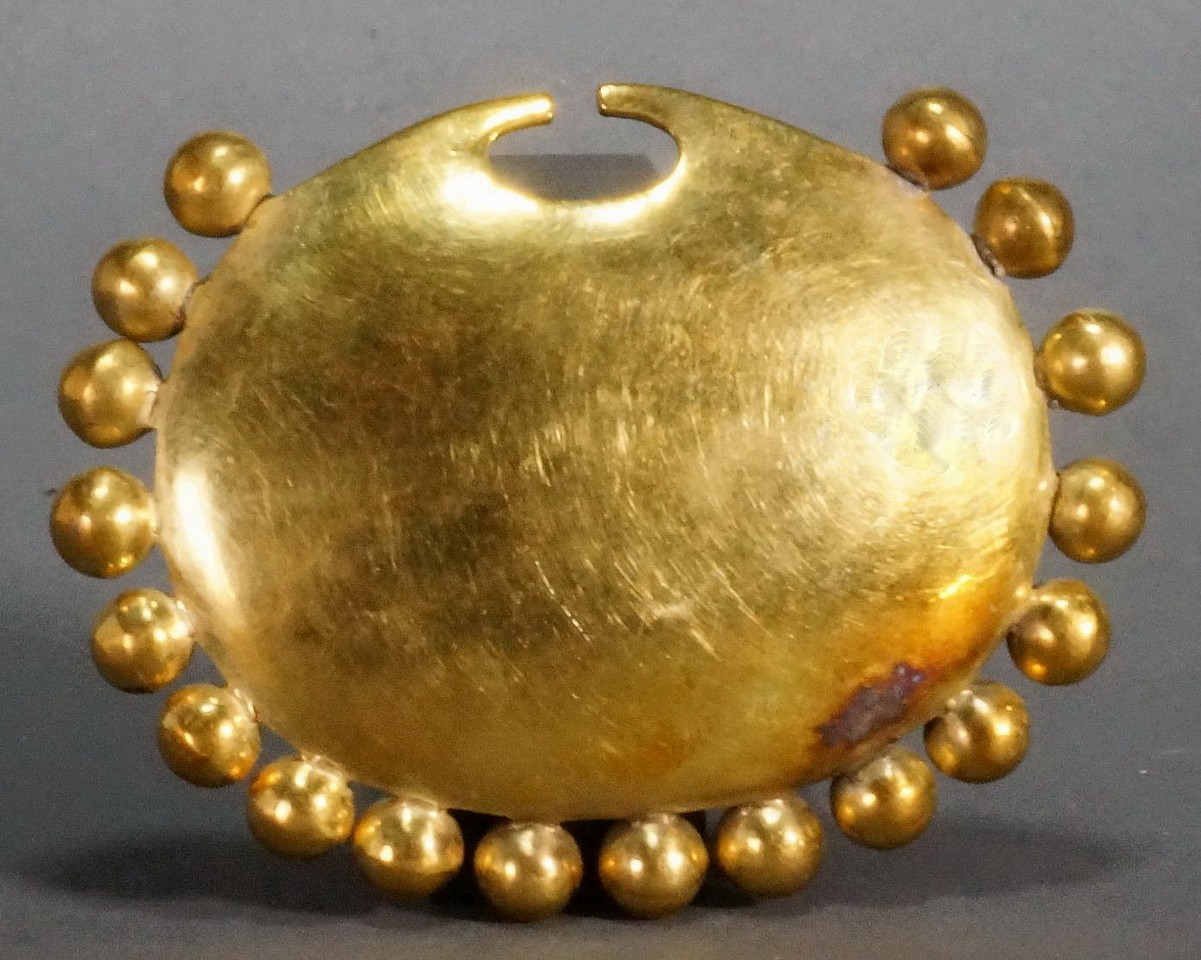 Peru, Moche Gold Nose Ornment Surrounded with 18 Spheres
Each of the spheres are individually soldered to the base.  Illustrated in Oro del Antiguo Peru, Lam. 134.  Ex collection Benno Mattel, prior to 1970, by descent to his daughter Karin Ashburn.
Media: Metal
Dimensions: Height: 5.5cm  x Width: 7cm , Weight: 27.3 grams
$27,500
n8020