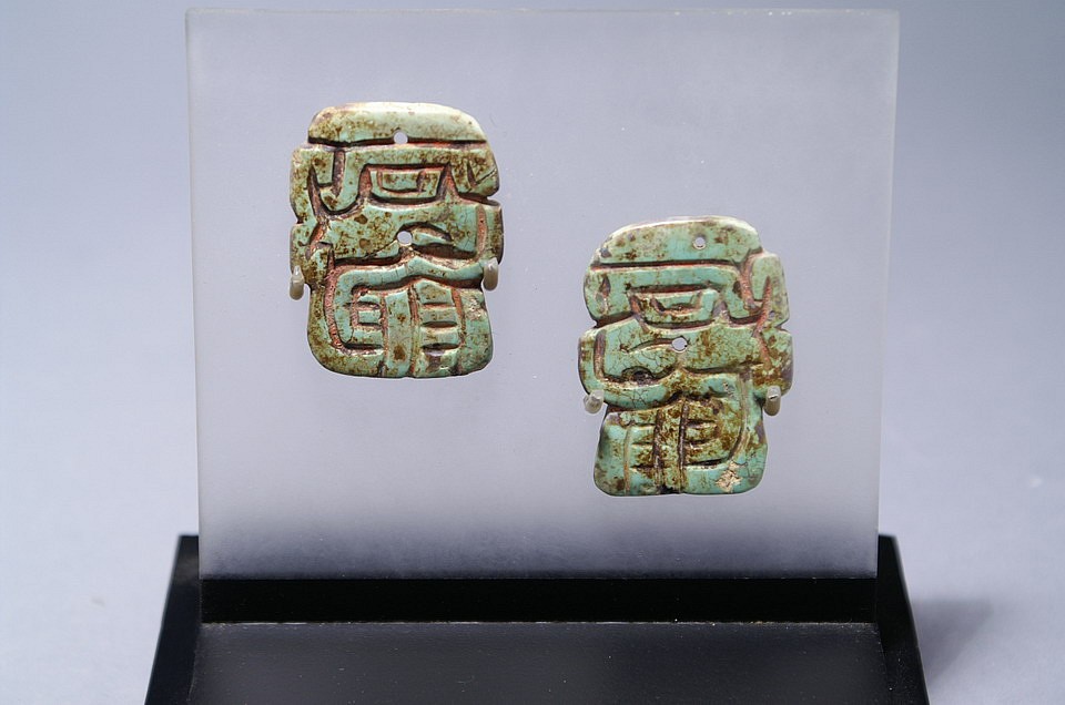 Peru, Chavin pair of Turquoise Plaques with Profile Faces
These faces could be trophy heads.  There are two small drill holes center arranged vertically.  It’s quite rare to find carved turquoise when most are made of shell.  These may have been use as pendants to a textile.   There is an abundance of manganese patina on the front.
Media: Stone
Dimensions: Height: 1 1/2" x Width 1 3/4"
$2,900
98046
