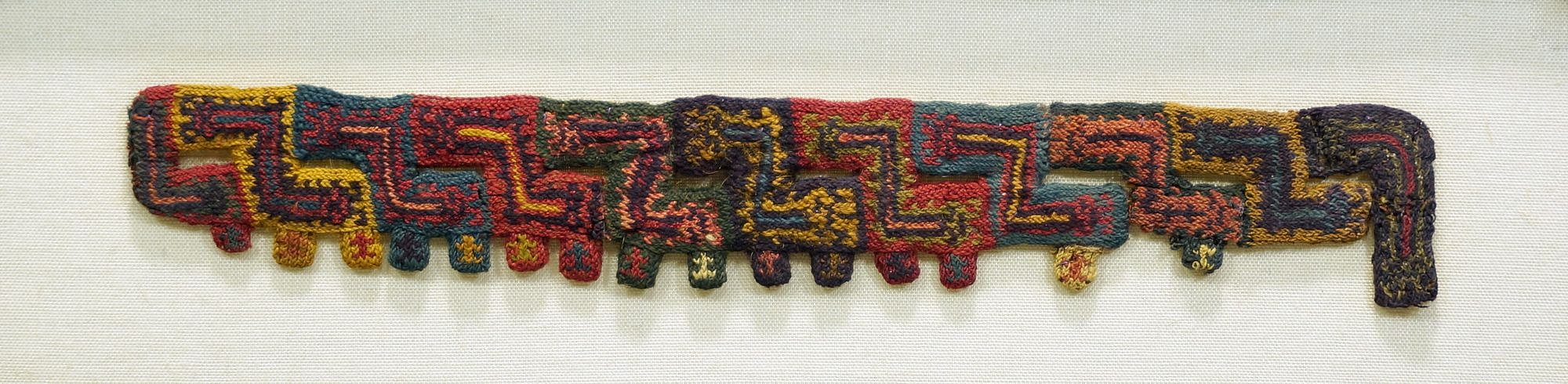 Peru, Paracas Miniature Knitted Fringe or Neck Opening with Double-Headed Worms
Eleven finely knitted colorful segments depicting double-headed worms with curled tails in alternating colors.  Below each worm is a small tab with an even smaller creature nested within.  Acquired from the estate of Anton Roeckl in Germany prior to 1970.
Media: Textile
Dimensions: Length: 6 3/4 inches
$2,800
96165