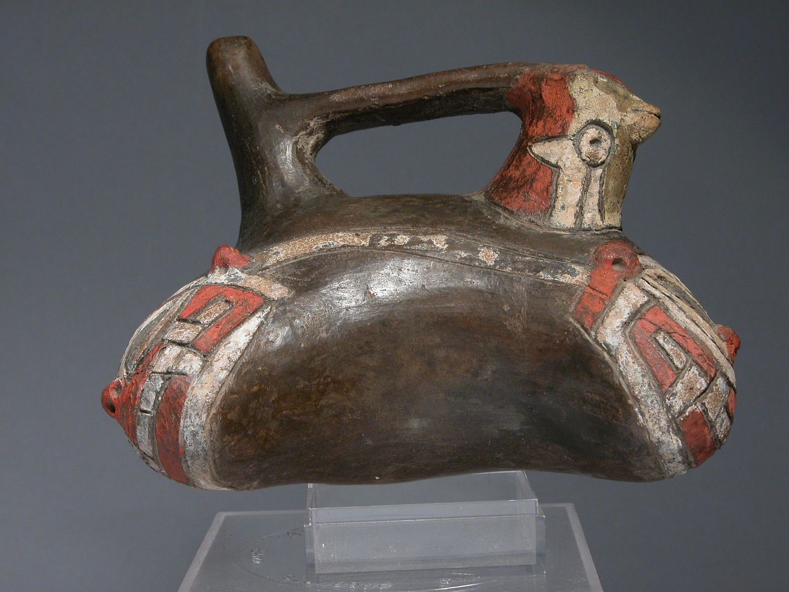 Peru, Paracas Callango Bridge Spout Effigy Vessel
This early "Callango" style vessel was painted with post-fire red and white pigments. This vessel combines two classic Andean elements: the eared falcon and the double-headed serpent.   The bridge has a blind spout decorated with an eared falcon, while the body represents the double-headed Rainbow Serpent, a key figure in Andean cosmology. The double-head serpent motif originated during the Chavin period, and likely represents the Amphisbaena fuligoninos – a snake that appears to have two heads  to intimidate predators. Both the eared falcon ad the double-headed snake motifs are illustrated in Christopher Donnan’s, "Ancient Peruvian Ceramics" in plates 51 and 2.  Acquired from Christie’s in 1998, previously in an old estate prior to 1970. Period: Peru, Paracas, Early Phase, South Coast, c. 900 - 600 BC
Media: Ceramic
Dimensions: Length: 5 1/2 x Height: 4"
$4,750
98429b
