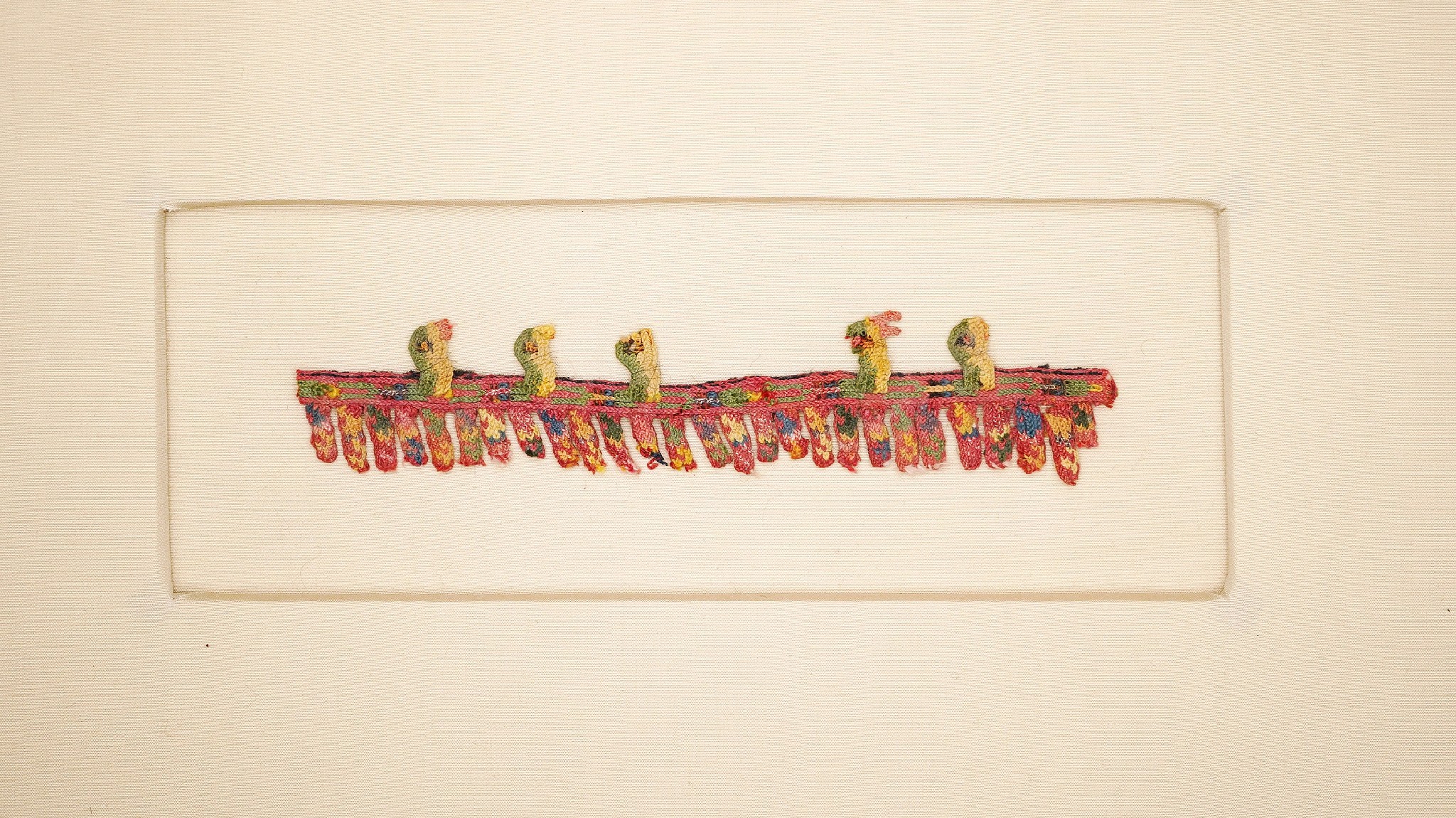 Peru, Paracas Border Fringe with Five Colorful Birds
This intricate border fringe was needle-knitted with a variety of colored threads made from natural plant and mineral dyes of the Andes.  The border fringe depicts 5 baby birds waiting in a nest with heads craned upwards, eagerly waiting to be fed some worms.  The fringe originally had six birds - one is missing to the right of center.  Excellent color.  Ex. collection Ferdinand Anton, Germany, prior to 1980.  Mounted on neutral cream-colored mat.
Peru, Paracas, Late Phase, South Coast, c. 200 BC - AD 100
Media: Textile
Dimensions: Width: 6 1/2" x Height: 1 1/2" Frame : 16" x 10"
$500
79040