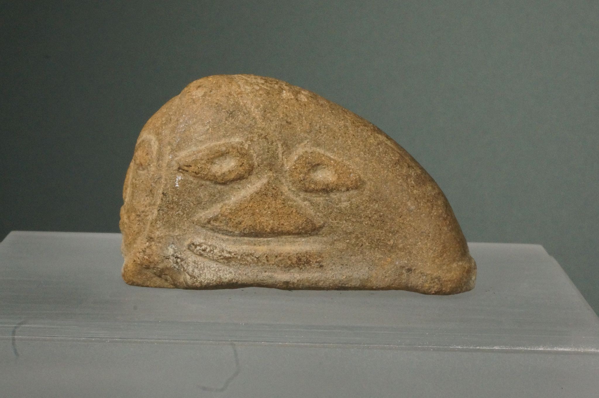 Dominican Republic, Unusual Carved Brown Stone with a Face on Front and on Side
This is a unique object with unknown use. One possibility is that it was  some a ritualistic amulet.
Period: Dominican Republic, Taíno , Early Classic Period, c. AD 600 - 1000
Media: Stone
Dimensions: Height" 2" x Length: 3"
89091