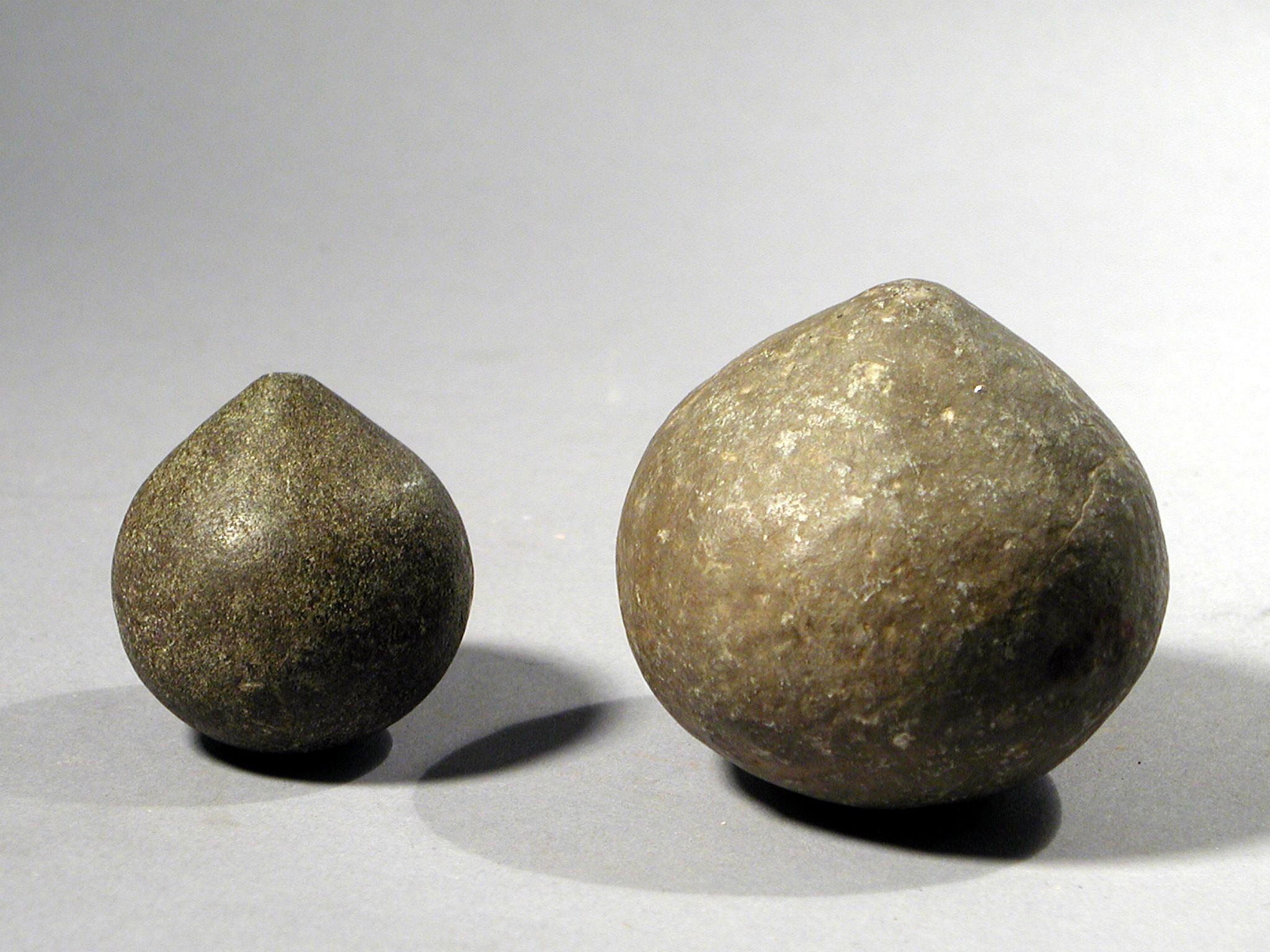 Dominican Republic, 2 Taíno  Spinning Tops
These are more than likely children's toys, similar to modern day tops.  They are often found buried with children.
Period: Dominican Republic, Taíno , c. AD 1000 - 1500
Media: Stone
Dimensions: D: 2 1/4" & 1 1/4
98133