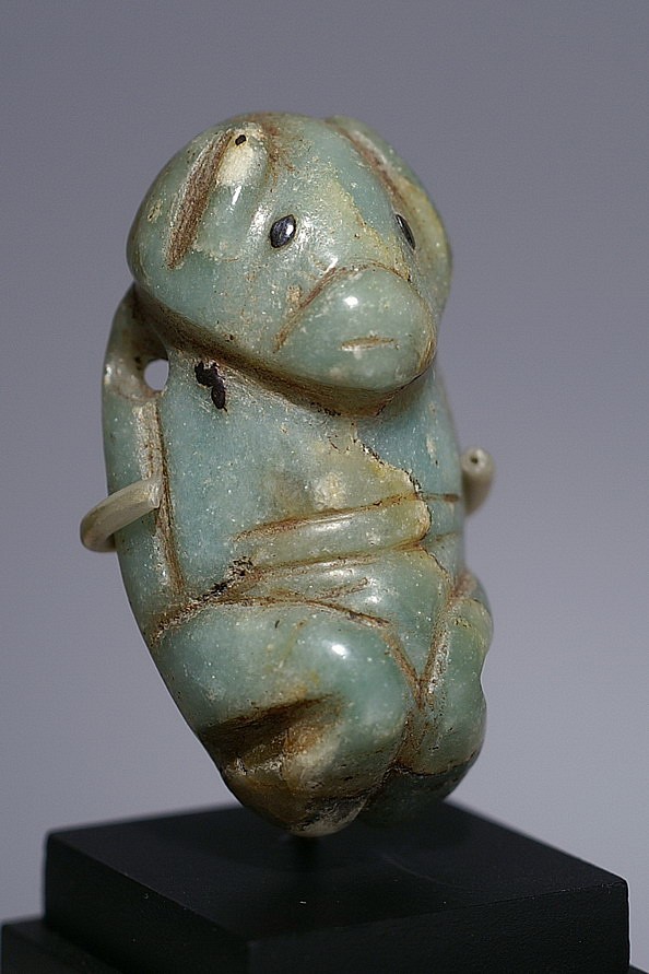 Dominican Republic, Mainland Green Stone Amulet of a Bat
It is extremely rare to find Taíno  amulets made from jade or jade-like stone.  The pointed ears, blunted muzzle, and the position of the extremities which resemble folded wings suggest that this is a bat idol. It's quite rare to see an amulet with inlaid stone eyes intact and perfectly set.
Period: Dominican Republic, Taíno , c. AD 1000 - 1500
Media: Stone
Dimensions: Height  1.5"
98220