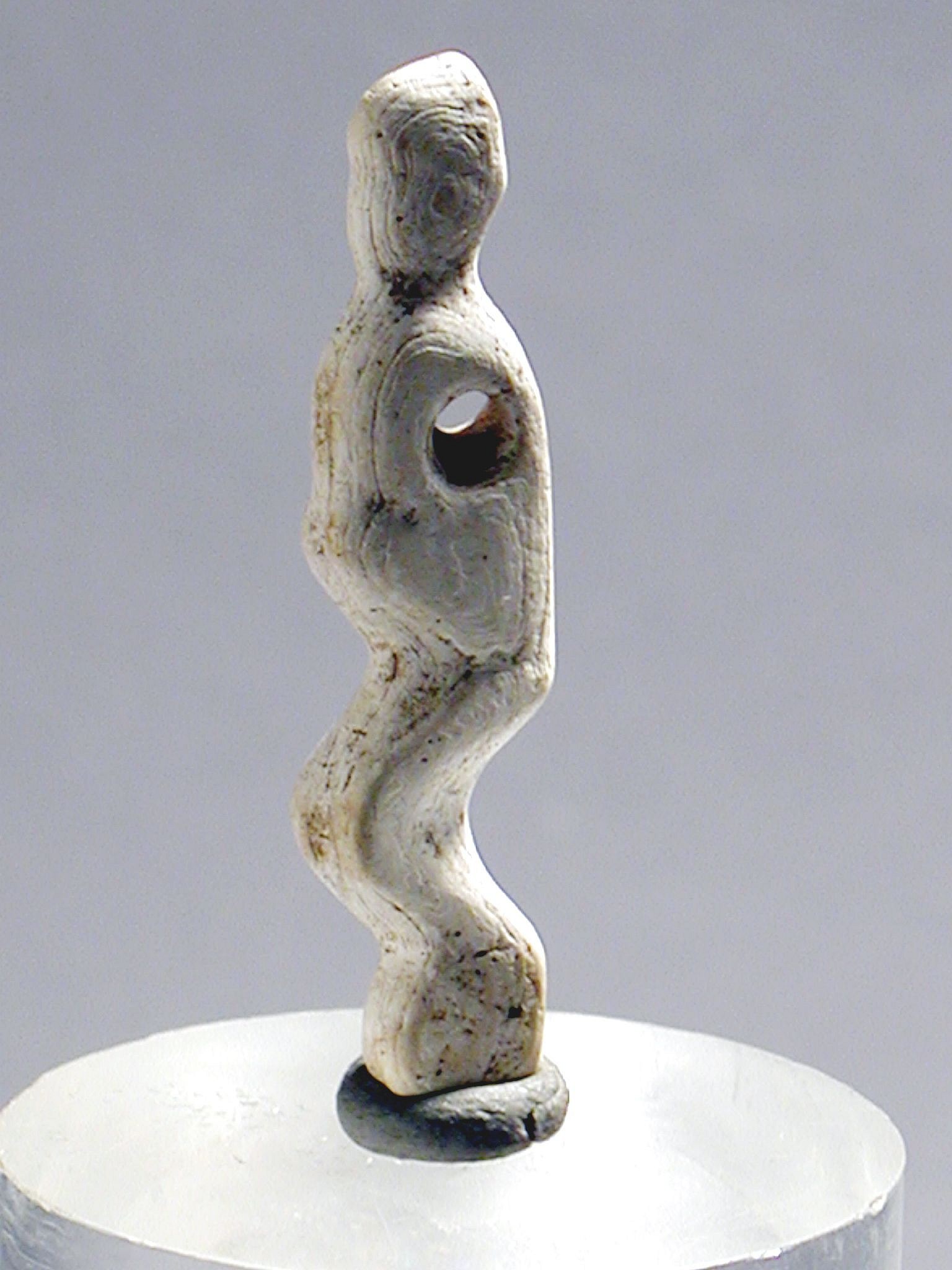 Dominican Republic, Taíno  Shell Figurative Silhouette Amulet
This slender, delicate figure is a marvel of Taíno  craftsmanship.  This shell was worked as an abstract crouching figure with eyes, arms and legs softly modeled, and the suspension hole drilled through the back.
Period: Dominican Republic, Taíno , c. AD 1000 - 1500
Media: Basket
Dimensions: Height: 1 7/8"
99342