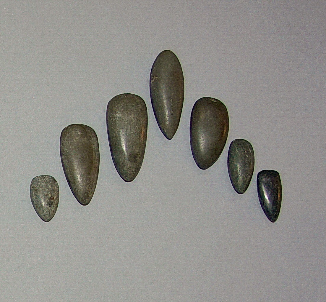 Dominican Republic, Seven Small Dark Greenstone Celts as Tools
Ranging in shape from oblong to petaloid, these stones were used as tools for fine work.  The varied shapes allowed for fine work a variety of sizes of amulets.
Period: Dominican Republic, Taíno , Early Classic Period, c. AD 600 - 1000
Media: Stone
Dimensions: Length: 1 1/4" to 2 7/8"
$1,500
99454