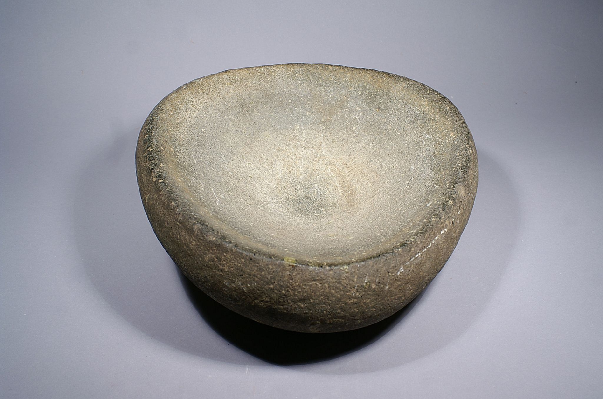 Dominican Republic, Taíno  Large Graystone Ovoid-Shaped Mortar
Large mortars were probably used for the preparation of foodstuffs in community festivals, of which this one is certainly representative.
Period: Dominican Republic, Taíno , c. AD 1000 - 1500
Media: Stone
Dimensions: Length: 13 1/2" inches x Height: 4 3/4" inches.
M7109