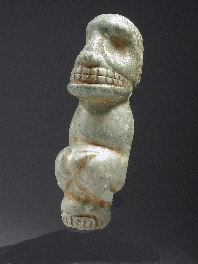 Dominican Republic, Taíno Green Stone Skeletal Figure Amulet in Crouching Position
Although small, this amulet probably had inlays of gold or shell in the eyes. It was carved from precious green stone - highly valued by the Taíno  because it was the color of the Caribbean Sea, the source of life and the threshold to the otherworld. It was probably a center pendant to a necklace. 
Period: Dominican Republic, Taíno , Early Classic Period, c. AD 600 - 1000
Media: Stone
Dimensions: Height 2"
MM245