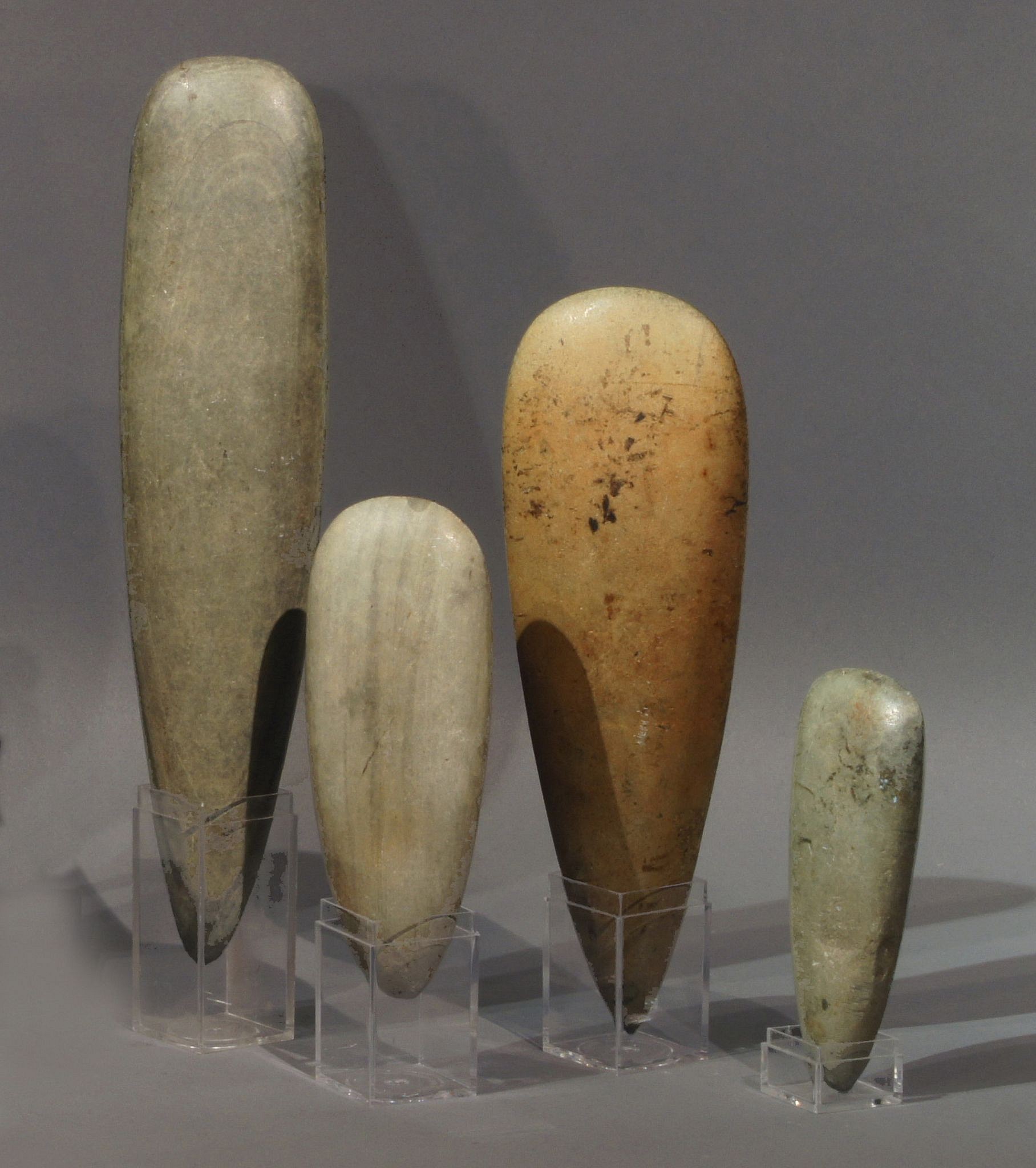 Dominican Republic, Group of Four Subcourian Ceremonial Petaloid Celts
These celts were selected for their lovely color and natural striations.  They show no signs of wear, which indicates that they were used ceremonially and were likely cherished by their owners and passed down through multiple generations.  Rene Herrera Fritot discussed and illustrated the configuration of celts in his 1964 book ESTUDIOS DE LAS HACHAS ANTILLANAS.
Period: Dominican Republic, NeolithicTaíno , Casimiroid, Courian Subseries, c. 2660 BC - AD 240
Media: Stone
Dimensions: Tallest: 9 1/4" -  Shortest: 3"
MM324